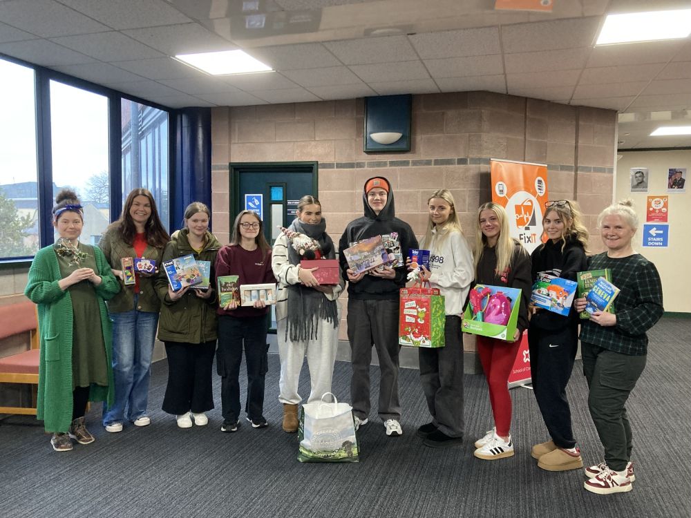 A Level students and lecturers with some of the gifts collected for local charities.